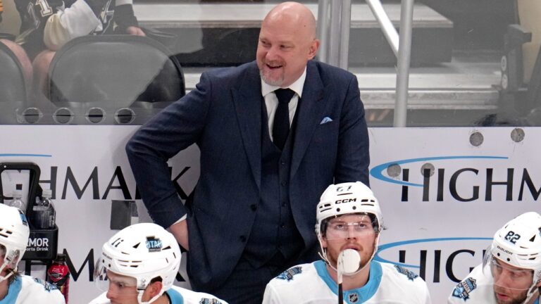 Utah Hockey Club head coach Andre Tourigny stands behind his bench during the third period of an NHL hockey game against the Pittsburgh Penguins, Saturday, Nov. 23, 2024, in Pittsburgh. Utah won 6-1. (AP Photo/Gene J. Puskar)