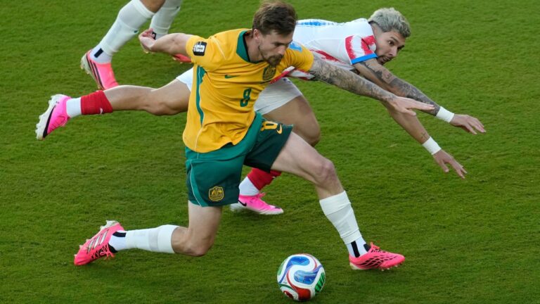 Australia's Connor Metcalfe (8) is pressured by Paraguay's Julio Enciso (19) during the World Cup Group D soccer match between Paraguay and Australia in Santa Clara, Calif., near San Francisco, Thursday, June 25, 2026. (AP Photo/Jeff Chiu)