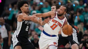 New York Knicks guard Jalen Brunson (11) is pressured by San Antonio Spurs guard Dylan Harper (2) during the first half of Game 1 of the NBA Finals basketball series, Wednesday, June 3, 2026, in San Antonio. (Eric Gay/AP)