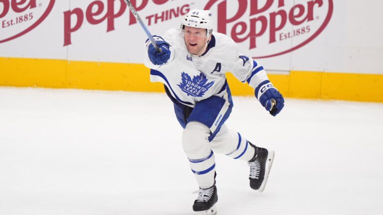 Toronto Maple Leafs defenseman Morgan Rielly reaches for the puck during the third period of an NHL hockey game against the Dallas Stars Sunday, Dec. 21, 2025, in Dallas. (AP Photo/LM Otero)