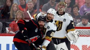 Carolina Hurricanes' Jordan Martinook (48) battles for position with Vegas Golden Knights' Shea Theodore (27) in front of goaltender Carter Hart (79) during the first period in Game 2 of the NHL hockey Stanley Cup Final series in Raleigh, N.C., Thursday, June 4, 2026. (Karl DeBlaker/AP)