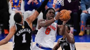 New York Knicks forward Og Anunoby (8) shoots between San Antonio Spurs forward Victor Wembanyama (1) and guard De'aaron Fox (4) during the first half of Game 4 of the NBA Finals basketball series, Wednesday, June 10, 2026, in New York. (Ross D. Franklin/AP)