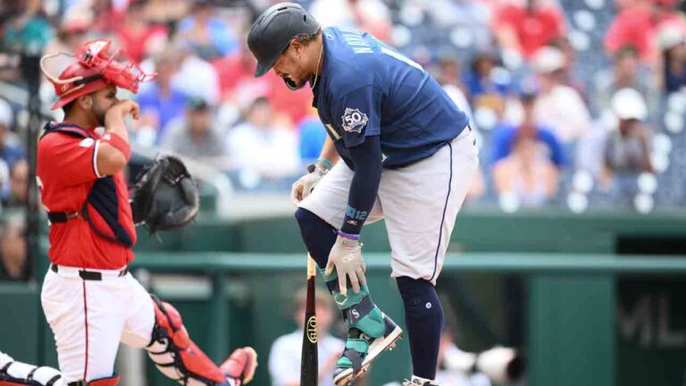 Seattle Mariners' Josh Naylor, right, reacts after he fouled the ball off his leg as Washington Nationals catcher Keibert Ruiz, left, looks on during the sixth inning of a baseball game Sunday, June 14, 2026, in Washington. (Nick Wass/AP)