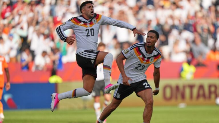 Germany's Nadiem Amiri leaps in the air as he celebrates after teammate Germany's Deniz Undav (26) scored their first goal during the World Cup Group E soccer match between Germany and Ivory Coast in Toronto, Saturday, June 20, 2026. (AP Photo/Stephanie Scarbrough)