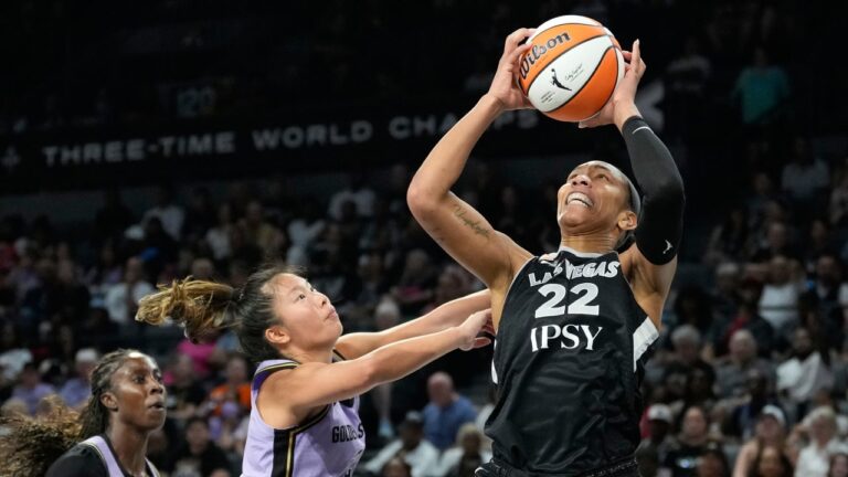 Las Vegas Aces center A'ja Wilson (22) grabs a rebound over Golden State Valkyries guard Kaitlyn Chen (2) during the second half of a WNBA basketball game Sunday, June 21, 2026, in Las Vegas. (AP Photo/John Locher)