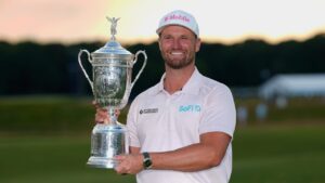 Wyndham Clark holds the trophy after winning the U.S. Open golf tournament at Shinnecock Hills Golf Club in Southampton, N.Y., Sunday, June 21, 2026. (AP Photo/Gerald Herbert)