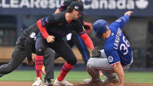 Texas Rangers left fielder Wyatt Langford (36) slides into second base with a steal ahead of a tag by Toronto Blue Jays infielder Ernie Clement (22) during first inning MLB baseball action in Toronto on Friday June 26, 2026. (Jon Blacker/CP)