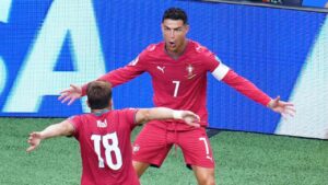 Portugal's Cristiano Ronaldo (7) celebrates with Portugal's Pedro Neto (18) after Ronaldo scored his side's third goal during the World Cup Group K soccer match between Portugal and Uzbekistan in Houston, Tuesday, June 23, 2026. (Karen Warren/AP)