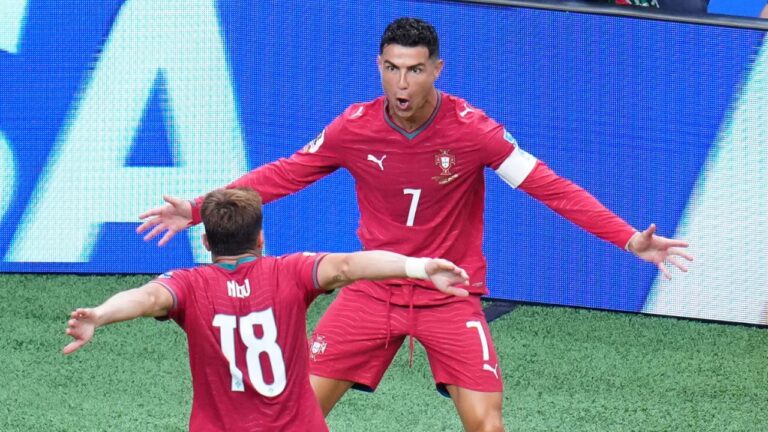 Portugal's Cristiano Ronaldo (7) celebrates with Portugal's Pedro Neto (18) after Ronaldo scored his side's third goal during the World Cup Group K soccer match between Portugal and Uzbekistan in Houston, Tuesday, June 23, 2026. (Karen Warren/AP)