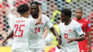Canada's Promise David (24) celebrates his goal against Switzerland with Nathan-Dylan Saliba (25) and Jonathan David (10) during the second half of a World Cup Group B soccer match, in Vancouver, on Wednesday, June 24, 2026. (Ethan Cairns/CP)
