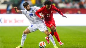 Canada's Jayden Nelson (29) battles against Uzbekistan's Aziz Amonov (28) during second half World Cup Friendly soccer action in Edmonton on Monday, June 1, 2026. (Codie McLachlan/CP)