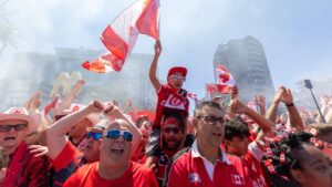 Canada’s Voyageurs soccer fans parade through the streets of Vancouver to BC Place. (Timothy Matwey/CP)
