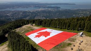 A giant Canadian flag is seen spread out on The Cut, a ski run at Metro Vancouver's Grouse Mountain ski resort. (CP/Grouse Mountain Resort)