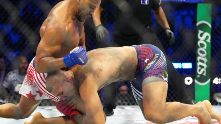 Alex Pereira, bottom, fights Ciryl Gane during their interim heavyweight title bout at UFC Freedom 250 on the South Lawn of the White House. (AP Photo/Alex Brandon)
