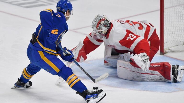 Detroit Red Wings goalie Sebastian Cossa makes a save against Buffalo Sabres right wing JJ Peterka during the shootout of an NHL hockey game in Buffalo, N.Y., Monday, Dec. 9, 2024. (AP Photo/Adrian Kraus)