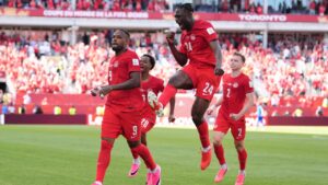 Cyle Larin (9) celebrates alongside teammate Promise David (24) after scoring Canada's goal in the second half of the World Cup Group B soccer match against Bosnia. (Sam Balkansky/AP)