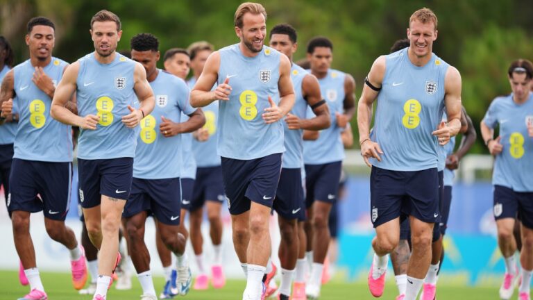 England's Harry Kane, center, jogs with teammates including Jordan Henderson, left, and Dan Burn, right, during a training for the national soccer team in Palm Beach Gardens, Fla., Tuesday, June 9, 2026, ahead of the World Cup soccer tournament. (AP Photo/Rebecca Blackwell)