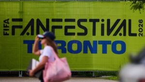 People pass signage outside the Fort York Toronto World Cup fan festival after a thunderstorm prompted an evacuation in Toronto, on Thursday, June 11, 2026. THE CANADIAN PRESS/Sammy Kogan