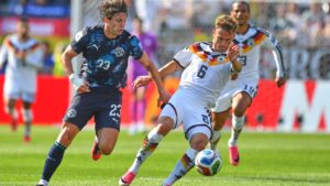 Paraguay's Matias Galarza (23) chases the ball down against Germany's Joshua Kimmich (6) during the World Cup round of 32 soccer match in Foxborough, Mass., near Boston, Monday, June 29, 2026. (AP Photo/Steven Senne)