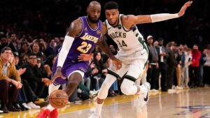 Los Angeles Lakers forward LeBron James, left, drives toward the basket as Milwaukee Bucks forward Giannis Antetokounmpo defends in the final seconds in the second half of an NBA basketball game Friday, Jan. 9, 2026, in Los Angeles. (AP Photo/Mark J. Terrill)