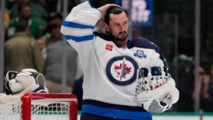 Winnipeg Jets goaltender Connor Hellebuyck stands by the net during a time out from play against the Dallas Stars in the first period of an NHL hockey game Thursday, April 2, 2026, in Dallas. (Tony Gutierrez/AP)