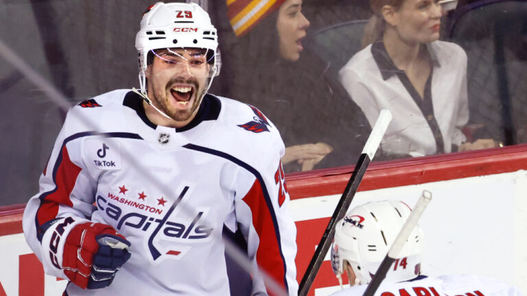 Washington Capitals' Hendrix Lapierre, left, celebrates his goal against the Calgary Flames with John Carlson during second period NHL hockey action in Calgary, Alta., Friday, Jan. 23, 2026. (Larry MacDougal/CP)