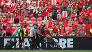 Canada's Ismael Kone is pushed in a wheelchair as he greets fans before the World Cup Group B soccer match between Switzerland and Canada. (Abbie Parr/AP)