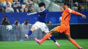 Japan's Ayase Ueda (18) and Netherlands' Virgil van Dijk battle for the ball during a World Cup Group F soccer match in Arlington, Texas, near Dallas, Sunday, June 14, 2026. (Julio Cortez/AP)