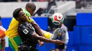 Canada's Jonathan David and South Africa's Mbekezeli Mbokazi battle for the ball during the World Cup round of 32 soccer match. (Gregory Bull/AP)