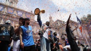 New York Knicks center Karl-Anthony Towns, center, celebrates with teammates during the New York Knicks' NBA championship parade Thursday, June 18, 2026, in New York. (AP Photo/Heather Khalifa)