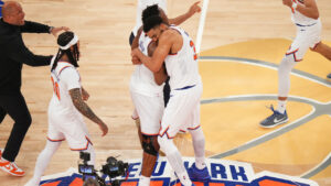 New York Knicks centre Karl-Anthony Towns (32) hugs forward Og Anunoby (8) after the team's victory over the San Antonio Spurs in Game 4 of the NBA Finals basketball series, Wednesday, June 10, 2026, in New York. (Frank Franklin II/AP)