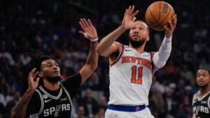 New York Knicks guard Jalen Brunson (11) shoots past San Antonio Spurs guard Stephon Castle during first half of Game 4 of the NBA Finals basketball series, Wednesday, June 10, 2026, in New York. (AP Photo/Ross D. Franklin)