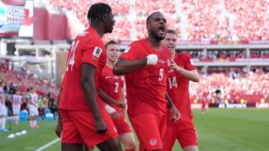 Canada's Cyle Larin (9) celebrates with teammates after scoring his sides first goal of the game in the second half of the World Cup Group B soccer match between Canada and Bosnia, Friday, June 12, 2026, in Toronto. (AP Photo/Sam Balkansky)