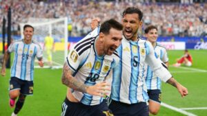 Argentina's Leandro Paredes (5) holds on to the shirt of teammate Lionel Messi celebrating after he scored their second goal during the World Cup Group J soccer match between Argentina and Austria in Arlington, Texas, near Dallas, Monday, June 22, 2026. (Julio Cortez/AP)