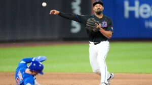 New York Mets' Marcus Semien, right, throws out Chicago Cubs' Seiya Suzuki at first base after forcing out Matt Shaw (6) for a double play during the sixth inning in the second baseball game of a doubleheader Wednesday, June 24, 2026, in New York. (AP Photo/Frank Franklin II)