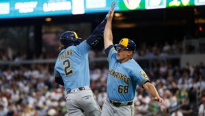 Milwaukee Brewers' Brice Turang (2) is greeted by third base coach Matt Erickson, right, as he rounds the bases after hitting a two-run home run during the third inning of a baseball game against the Athletics, Monday, June 8, 2026, in Las Vegas. (Caroline Brehman/AP)