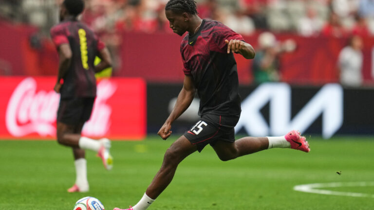 Defender Moise Bombito warms up before a World Cup match for Canada. (Abbie Parr/AP)