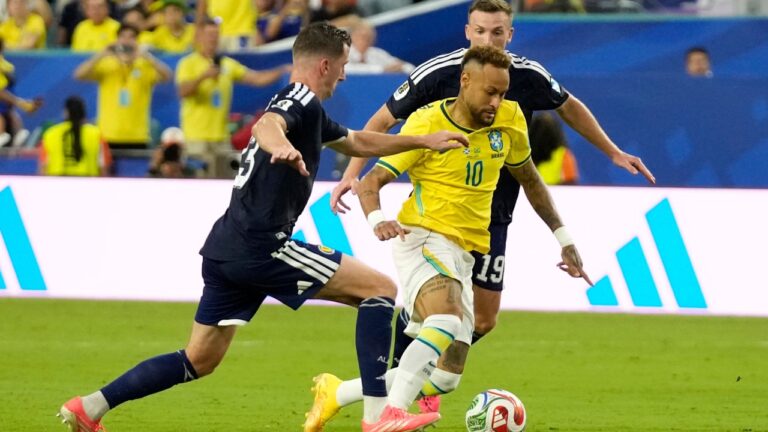 Brazil's Neymar (10) challenges for the ball with Scotland's Kenny McLean (23) and Lewis Ferguson (19) during the World Cup Group C soccer match between Scotland and Brazil in Miami Gardens, Fla., Wednesday, June 24, 2026. (AP Photo/Lynne Sladky)