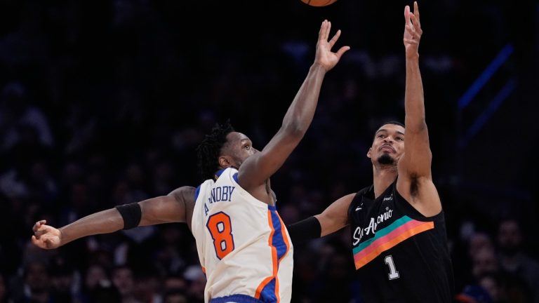New York Knicks' OG Anunoby, left, blocks a pass headed for San Antonio Spurs' Victor Wembanyama during the first half of an NBA basketball game Sunday, March 1, 2026, in New York. (Seth Wenig/AP)