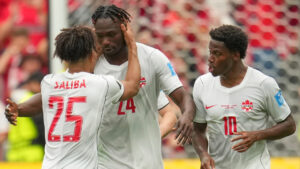 Promise David (24) celebrates with Canadian teammates Nathan Saliba (25) and Jonathan David (10) after scoring Canada's lone goal vs. Switzerland in a Group B match at the FIFA World Cup. (Abbie Parr/AP)