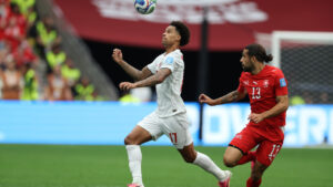 Canada's Tajon Buchanan (17) and Switzerland's Ricardo Rodriguez (13) chase the ball during the World Cup Group B action. (Sydney Shankman/AP)