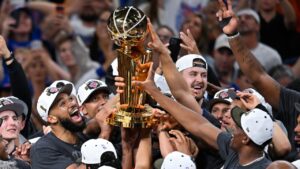 The New York Knicks celebrate with the Larry O'Brien Championship Trophy after defeating the San Antonio Spurs in Game 5 of the NBA Finals basketball series, Saturday, June 13, 2026, in San Antonio. (Darren Abate/AP)