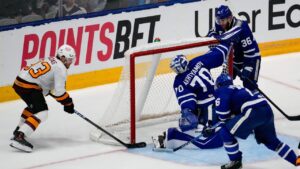 Chicago Wolves centre Justin Robidas (93) scores a goal on Toronto Marlies goaltender Artur Akhtyamov (70) during the third period in Game 4 of the AHL Calder Cup Final in Toronto on Thursday, June 18, 2026. THE CANADIAN PRESS/Arlyn McAdorey