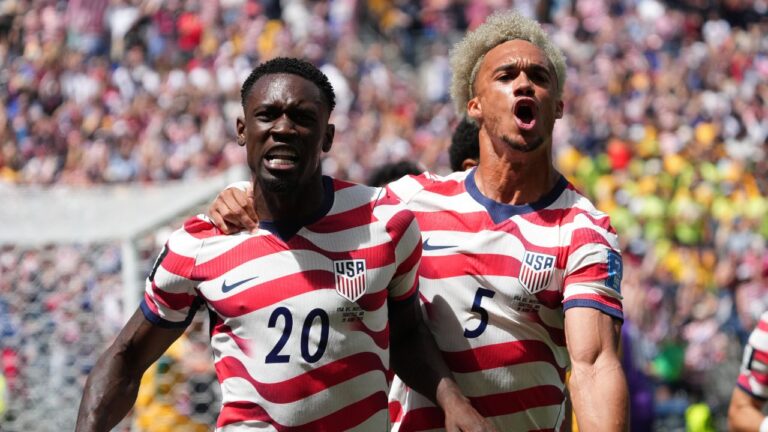 United States' Folarin Balogun (20) and Antonee Robinson (5) celebrate after scoring during the World Cup Group D soccer match between the United States and Australia in Seattle, Friday, June 19, 2026. (AP Photo/Ted S. Warren)