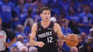 Phoenix Suns guard Collin Gillespie handles the ball during the first half in Game 1 of a first-round NBA playoffs basketball series against the Oklahoma City Thunder, Sunday, April 19, 2026, in Oklahoma City. (AP Photo/Nate Billings)