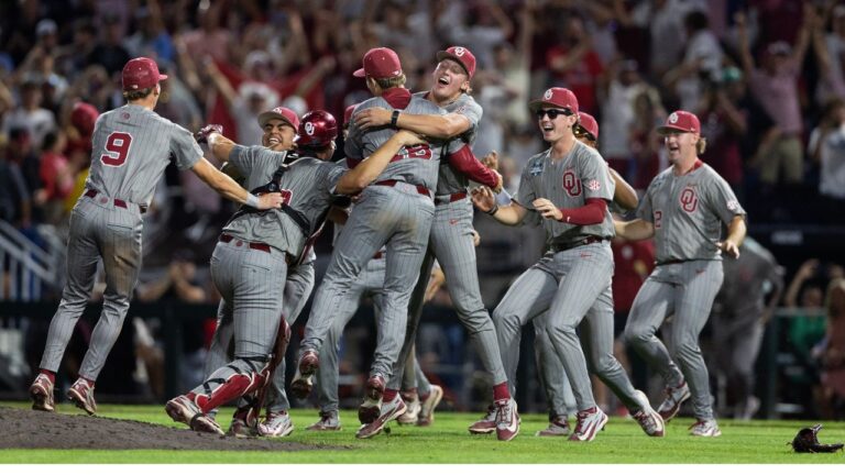 Oklahoma's Nick Wesloski, center, hugs closing pitcher Jackson Cleveland, center left, as they celebrate after defeating North Carolina in Game 3 of the NCAA College World Series baseball finals in Omaha, Neb., Monday, June 22, 2026. (AP Photo/Rebecca S. Gratz)