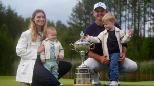 American Bud Cauley and his wife and children smile as they knee and stand beside the trophy after he won the RBC Canadian Open in Caledon, Ont. on Sunday June 14, 2026. THE CANADIAN PRESS/Frank Gunn