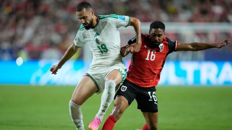 Algeria's Nabil Bentaleb (19) and Austria's Phillip Mwene (16) compete for the ball during the World Cup Group J soccer match between Algeria and Austria in Kansas City, Mo., Saturday, June 27, 2026. (AP Photo/Charlie Riedel)