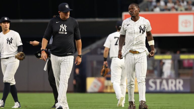 New York Yankees' Jazz Chisholm Jr., right, walks to the dugout after colliding with teammate Jasson Domínguez during the fourth inning of a baseball game against the Detroit Tigers, Monday, June 29, 2026, in New York. (AP Photo/Pamela Smith)