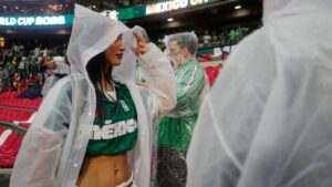 A fan wears a poncho as it rains ahead of the World Cup round of 32 soccer match between Mexico and Ecuador in Mexico City, Tuesday, June 30, 2026. (AP Photo/Ricardo Mazalan)